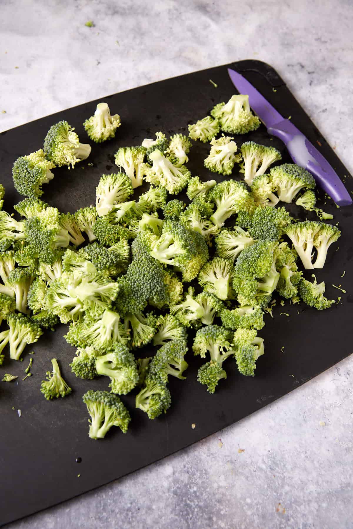 Chopped broccoli on a cutting board.