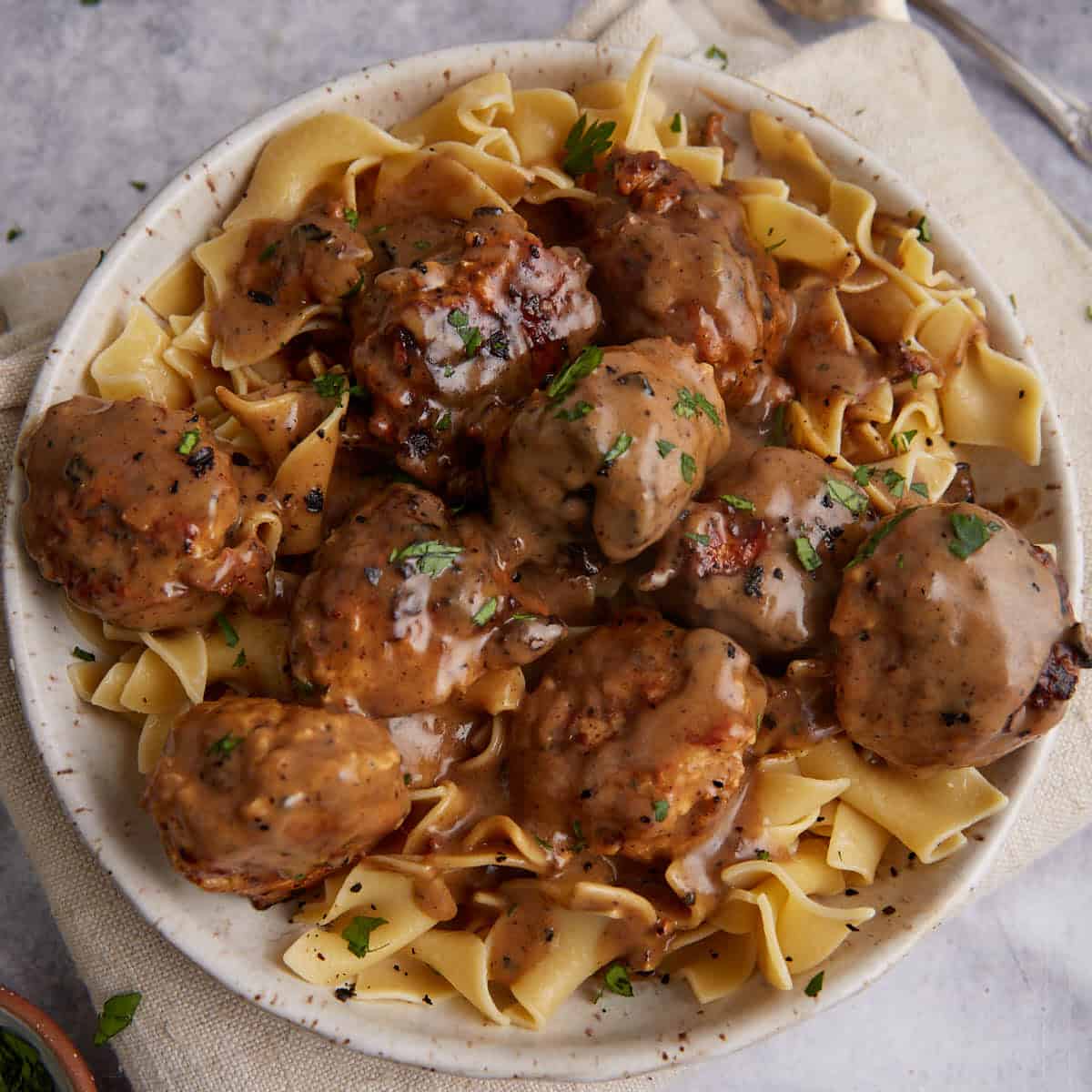 Ground chicken meatballs covered in Marsala sauce over egg noodles.