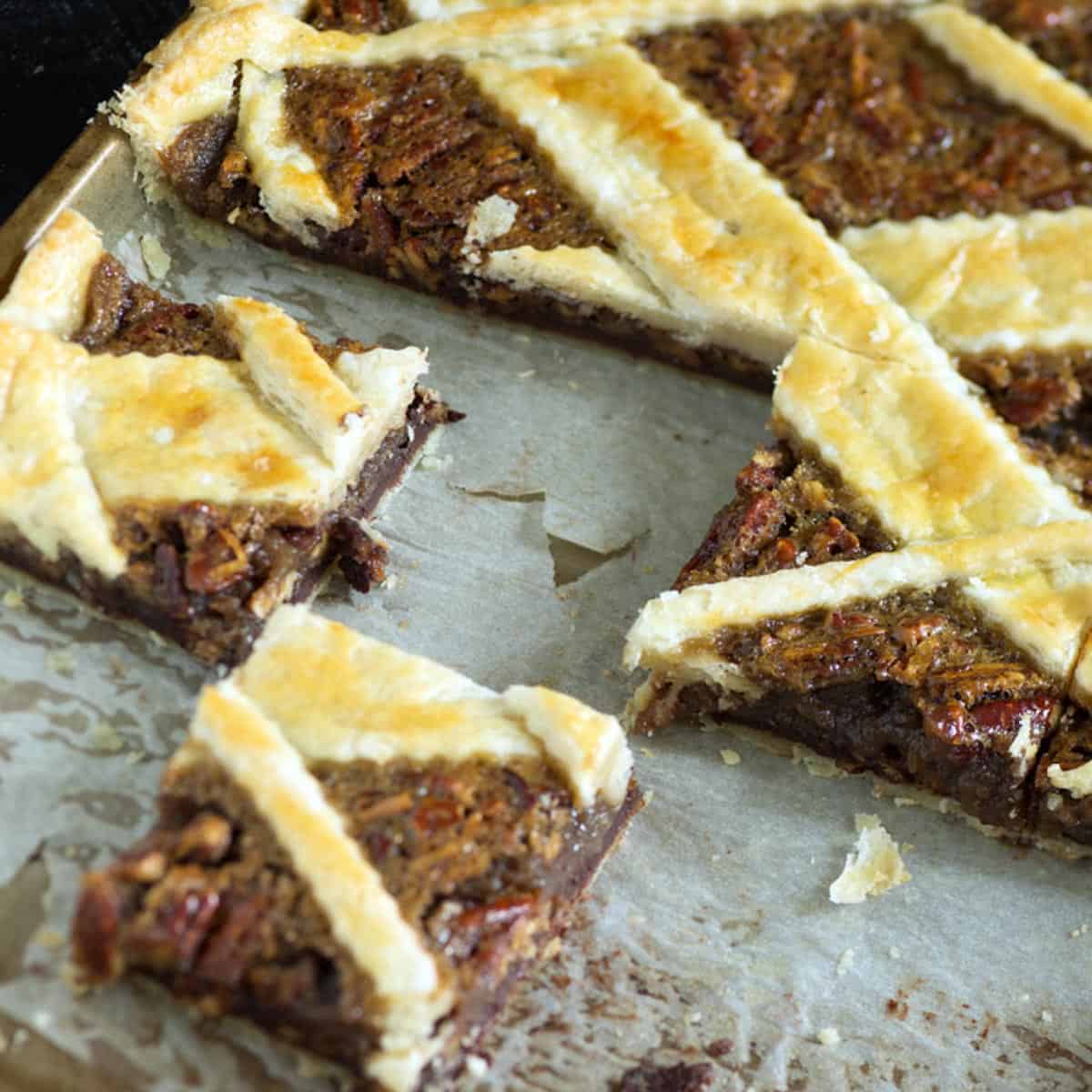 A pecan slab pie cut into squares.