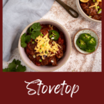 A bowl of beef chili with cheese on top.