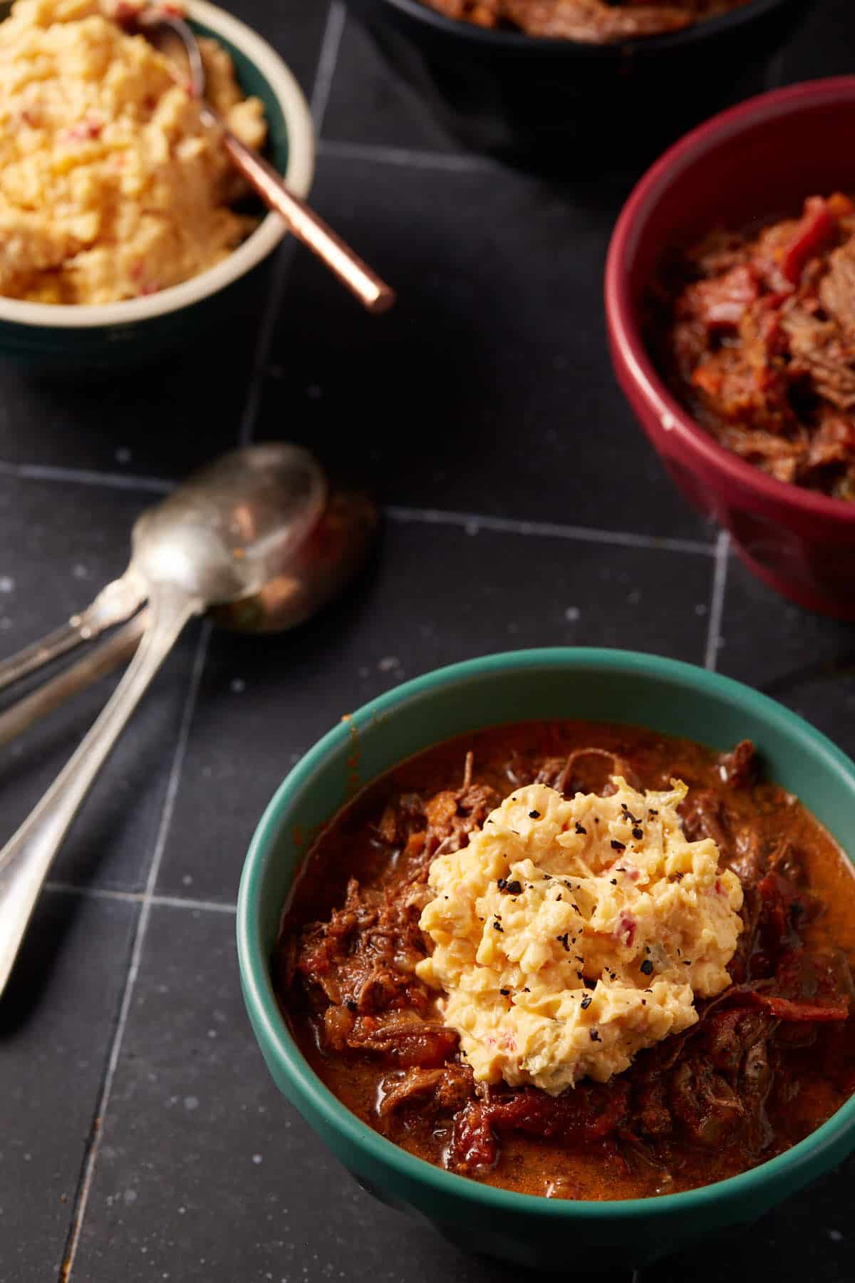 A bowl of chili topped with pimento cheese.