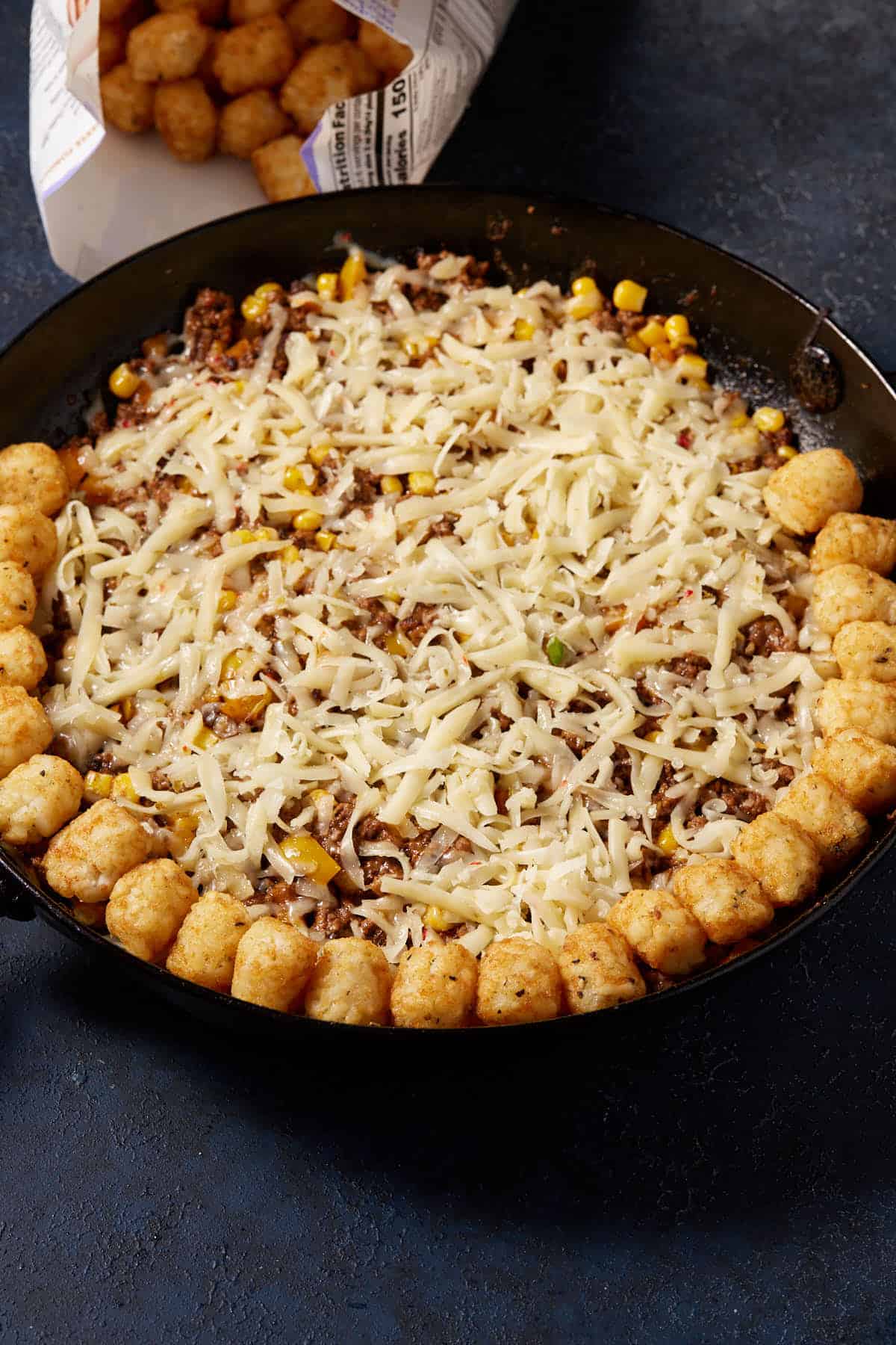 A row of tater tots on top of the casserole.