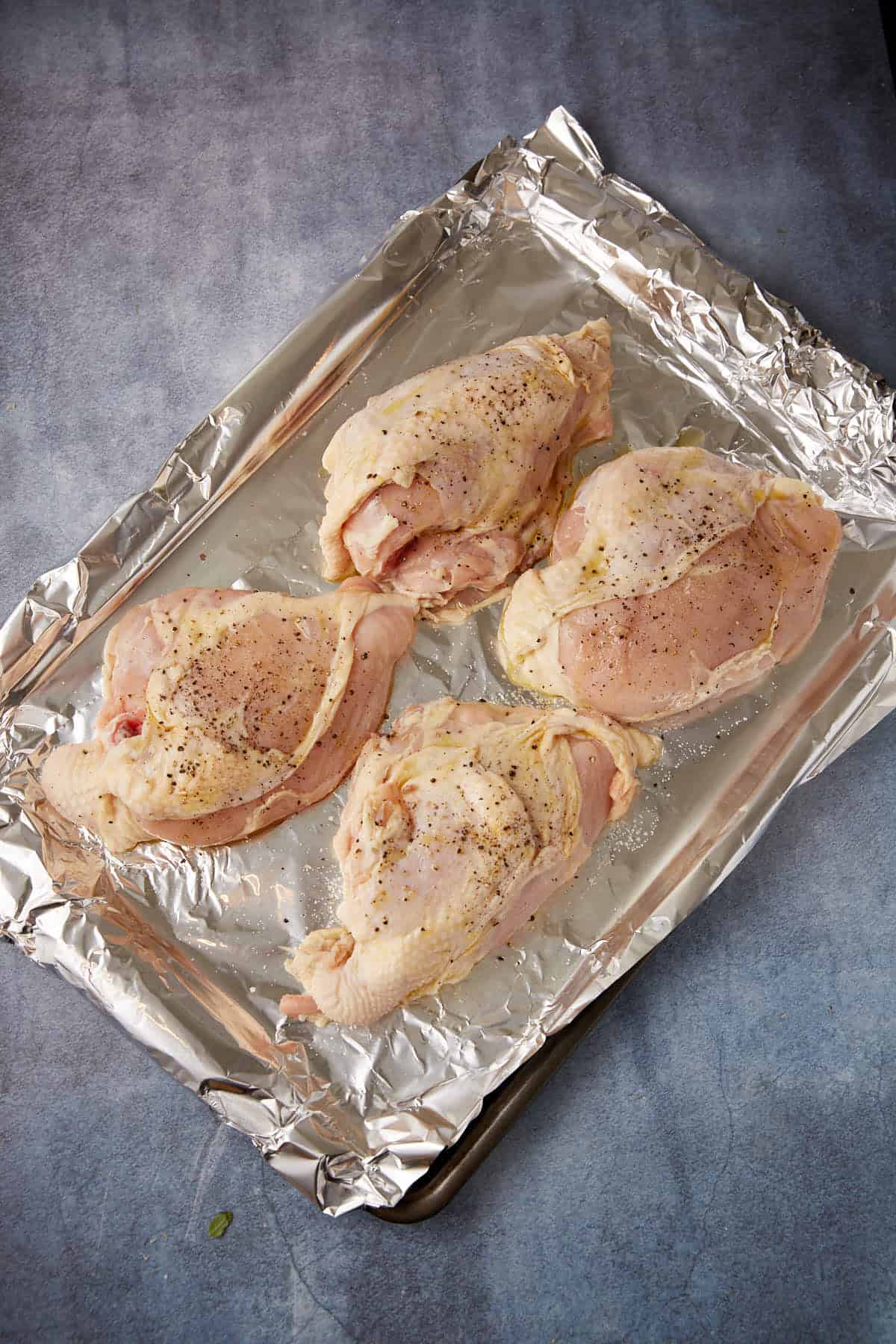 Chicken breasts on a baking sheet.