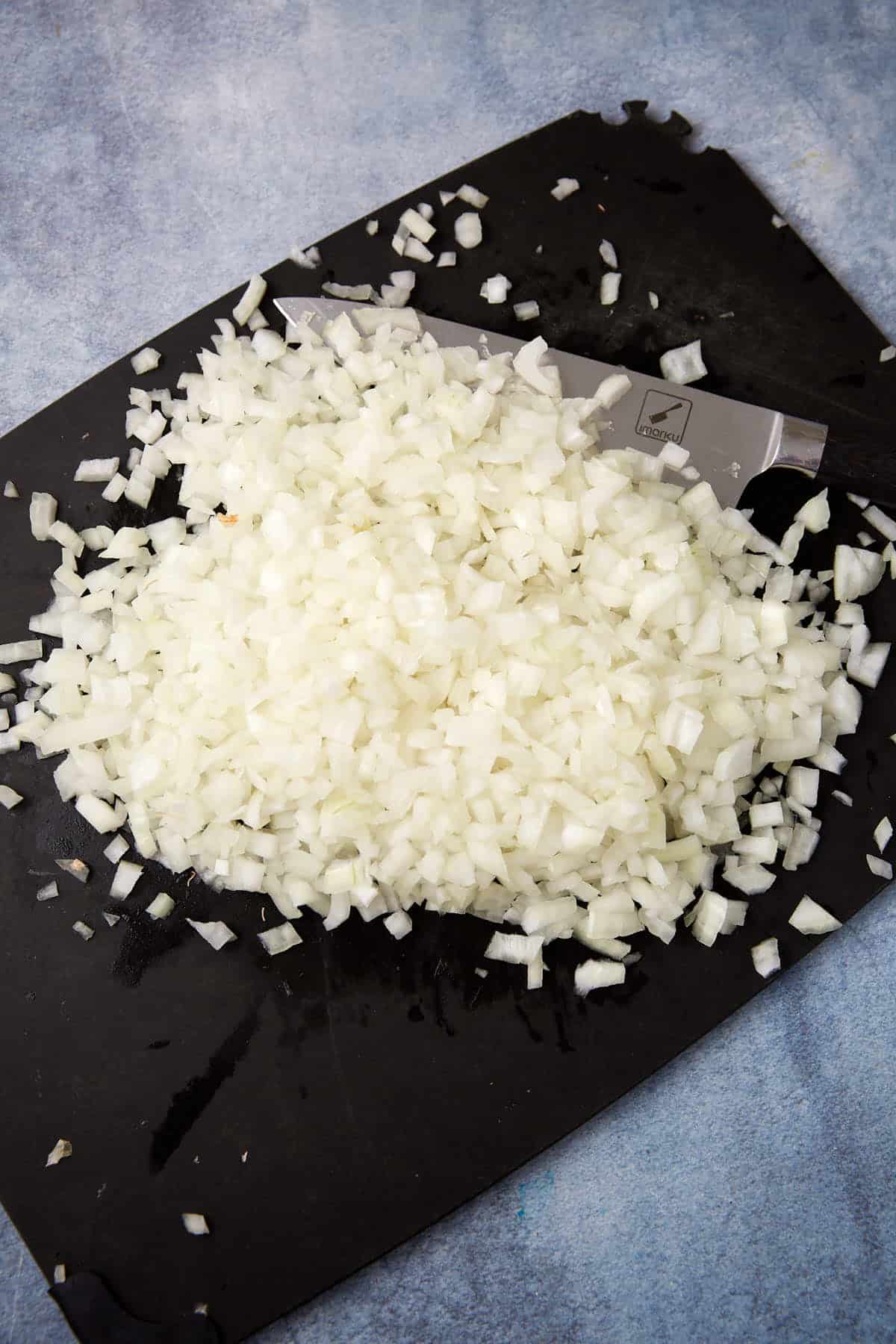 Onions chopped on a cutting board.