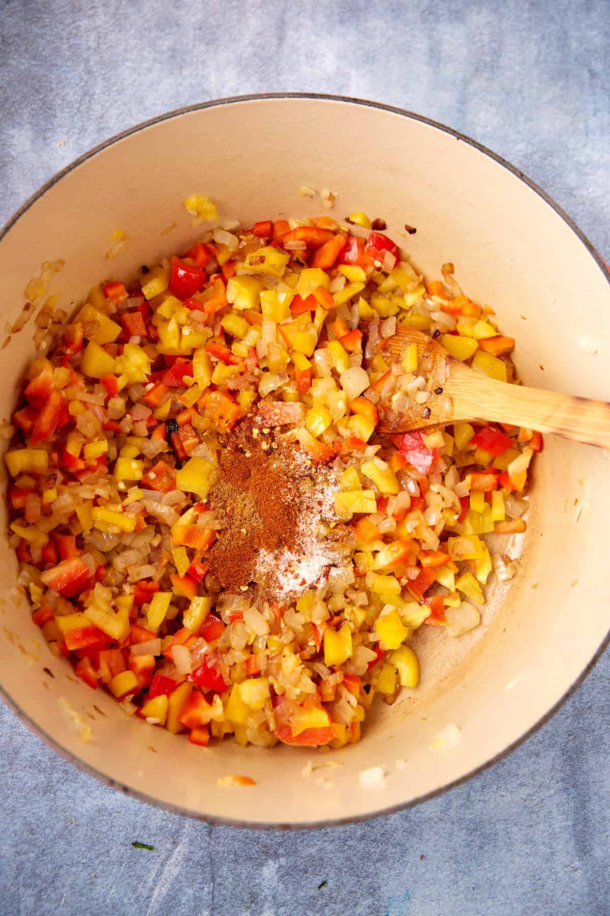Peppers and onions in a soup pot.