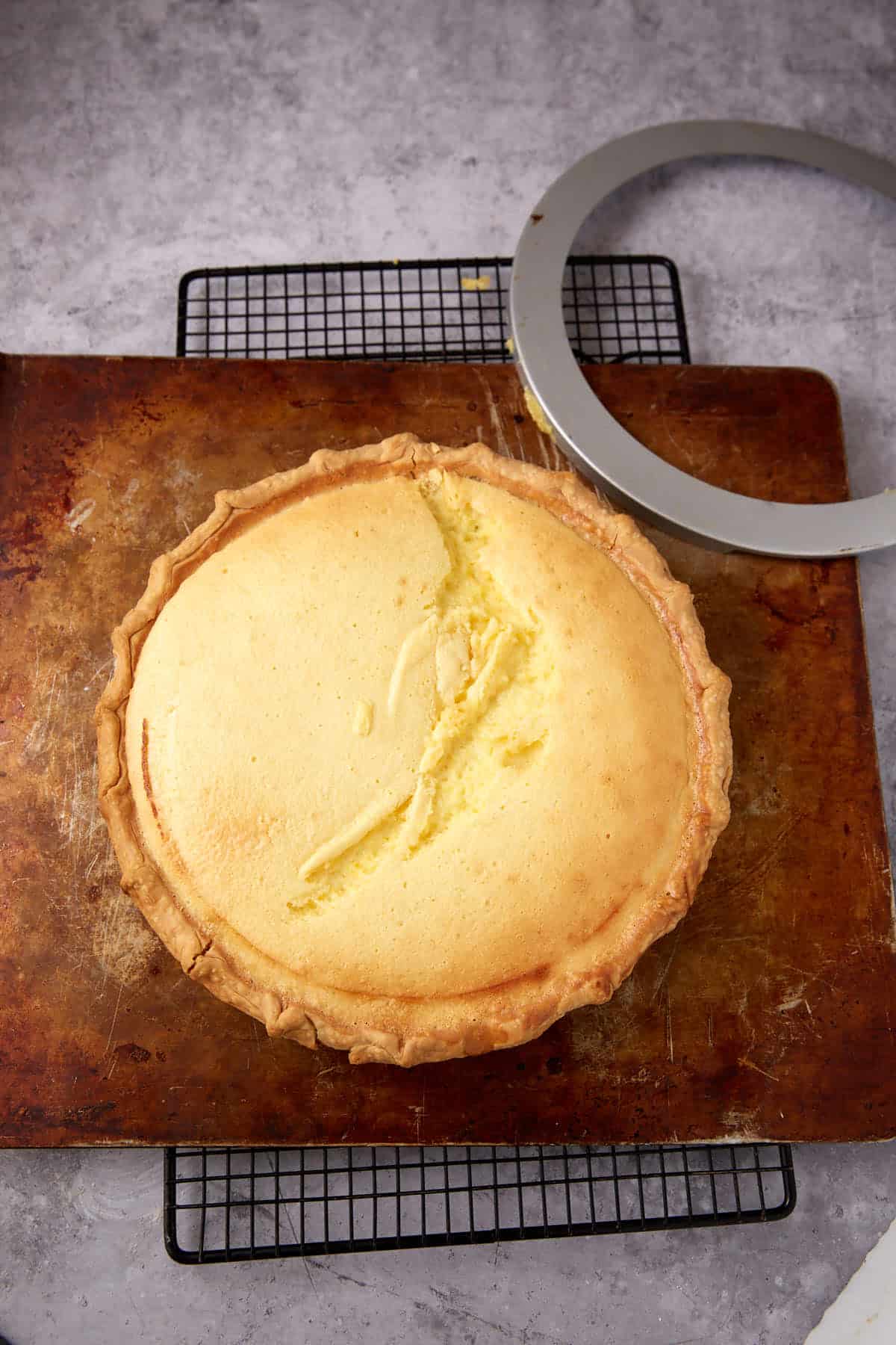 A lemon chess pie with a dent across the center.