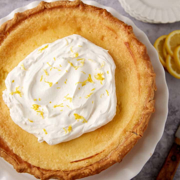A lemon chess pie topped with whipped cream.