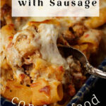 A spoon full of penne with sausage.