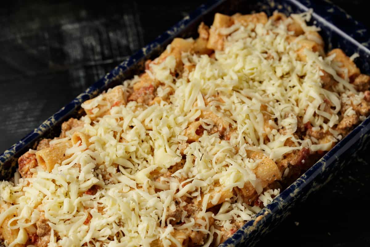A baking dish with pasta alla vodka in it before baking.