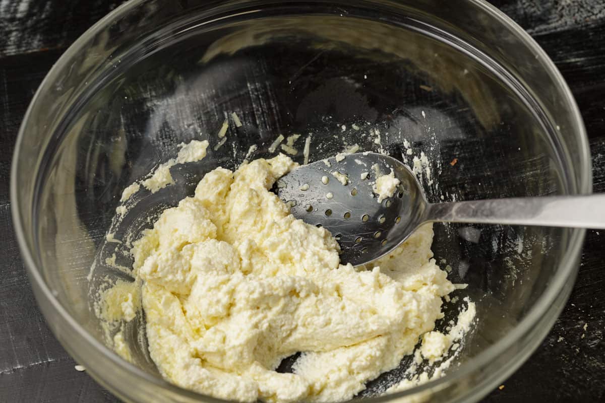 The cheese mixture in a glass bowl.