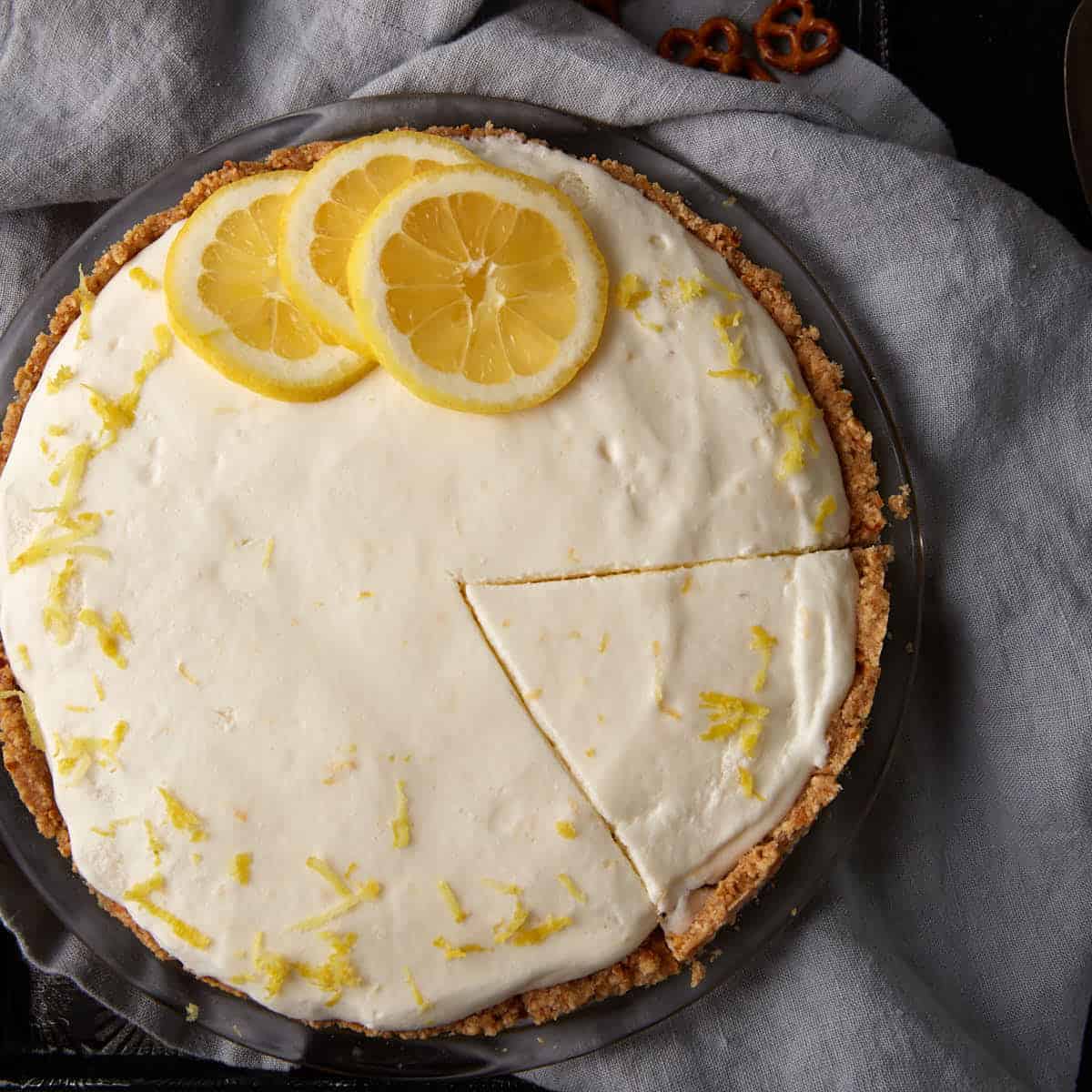 A lemon chiffon pie topped with lemon slices.