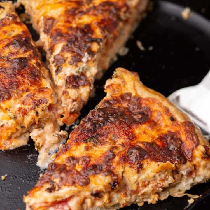 A slice of a southern tomato galette in a skilleet