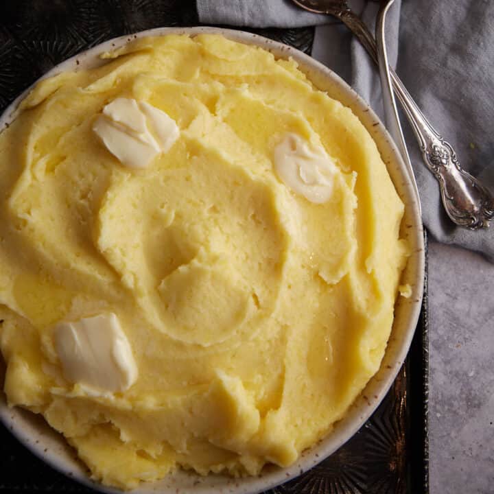 A serving bowl of creamy mashed potatoes.
