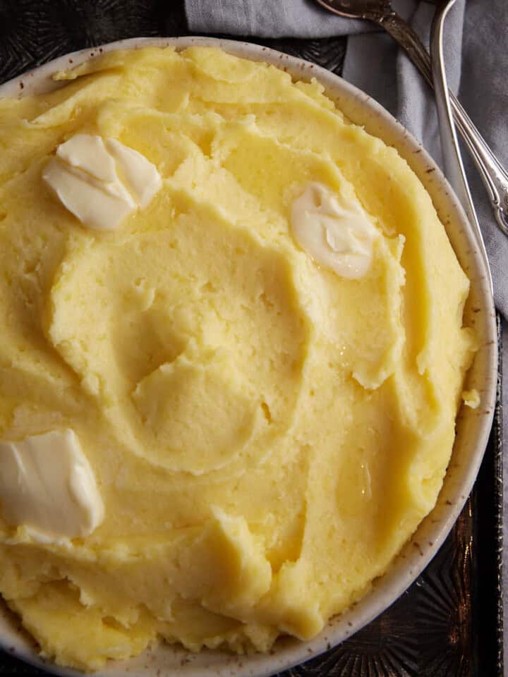A serving bowl of creamy mashed potatoes.