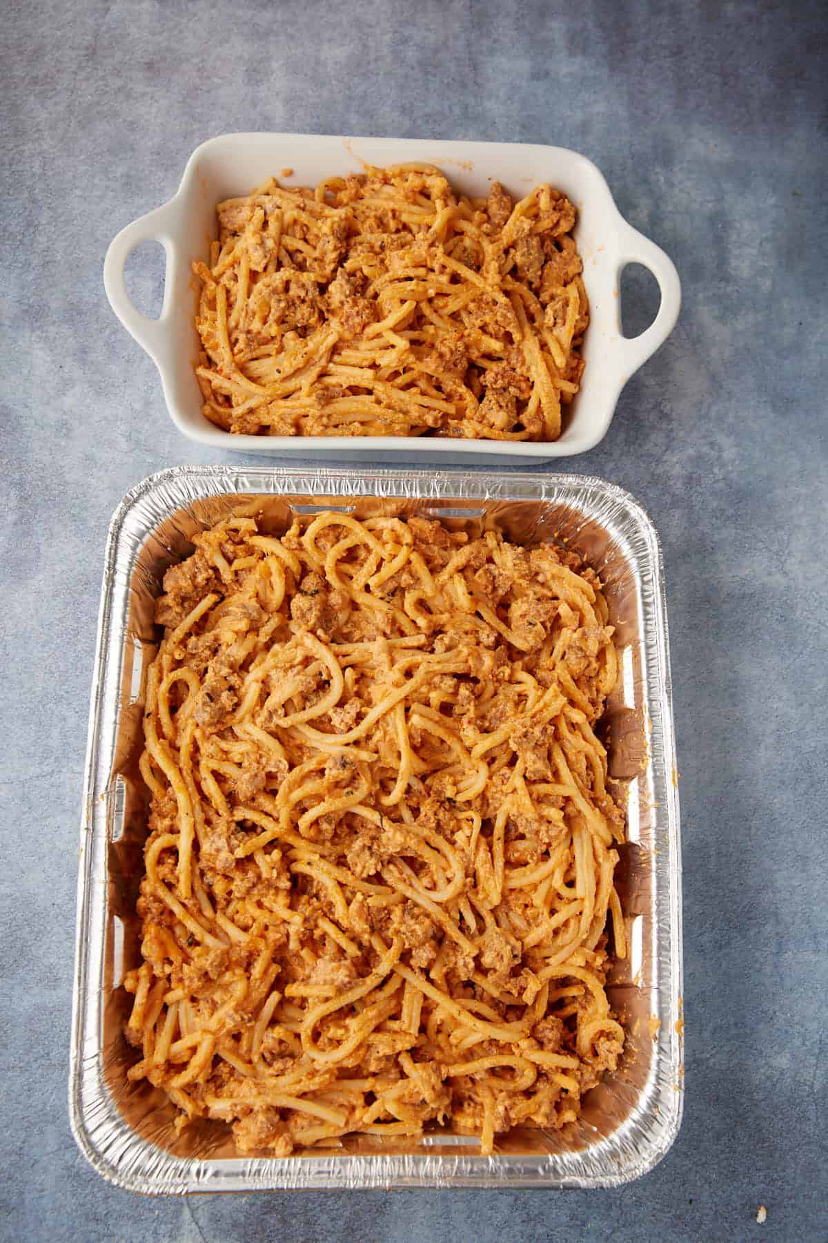 Spaghetti casserole in a serving pan before it has baked.