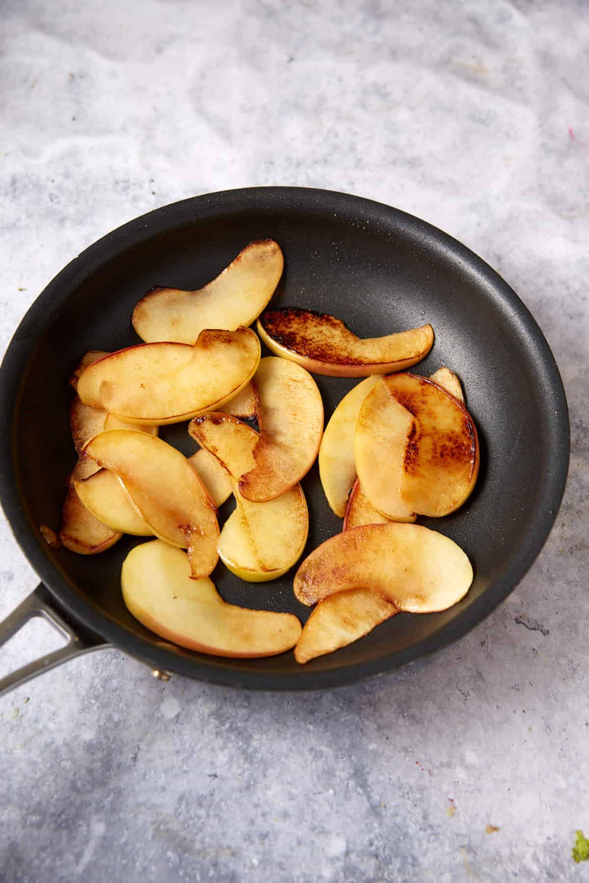 Cooked apples in a skillet.