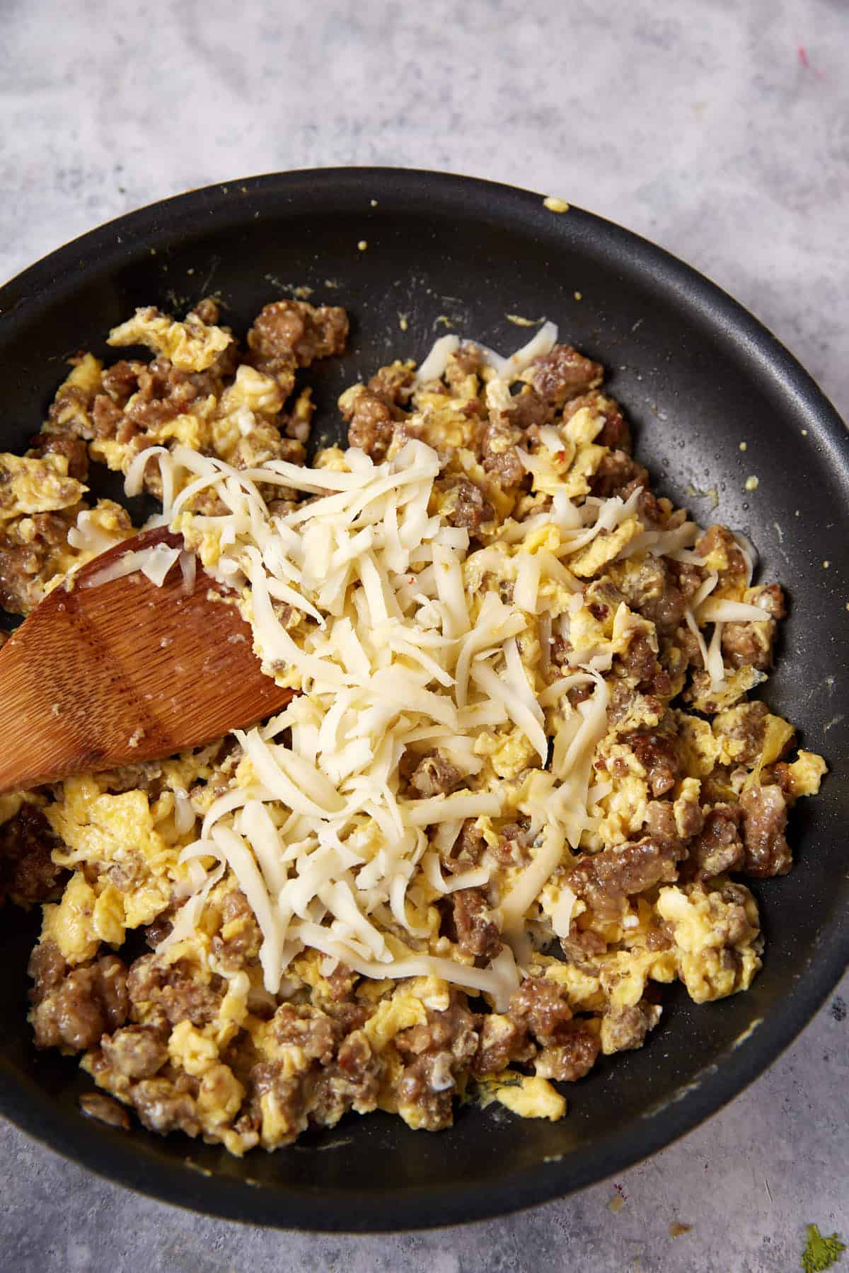 Sausage, egg and cheese in a skillet.