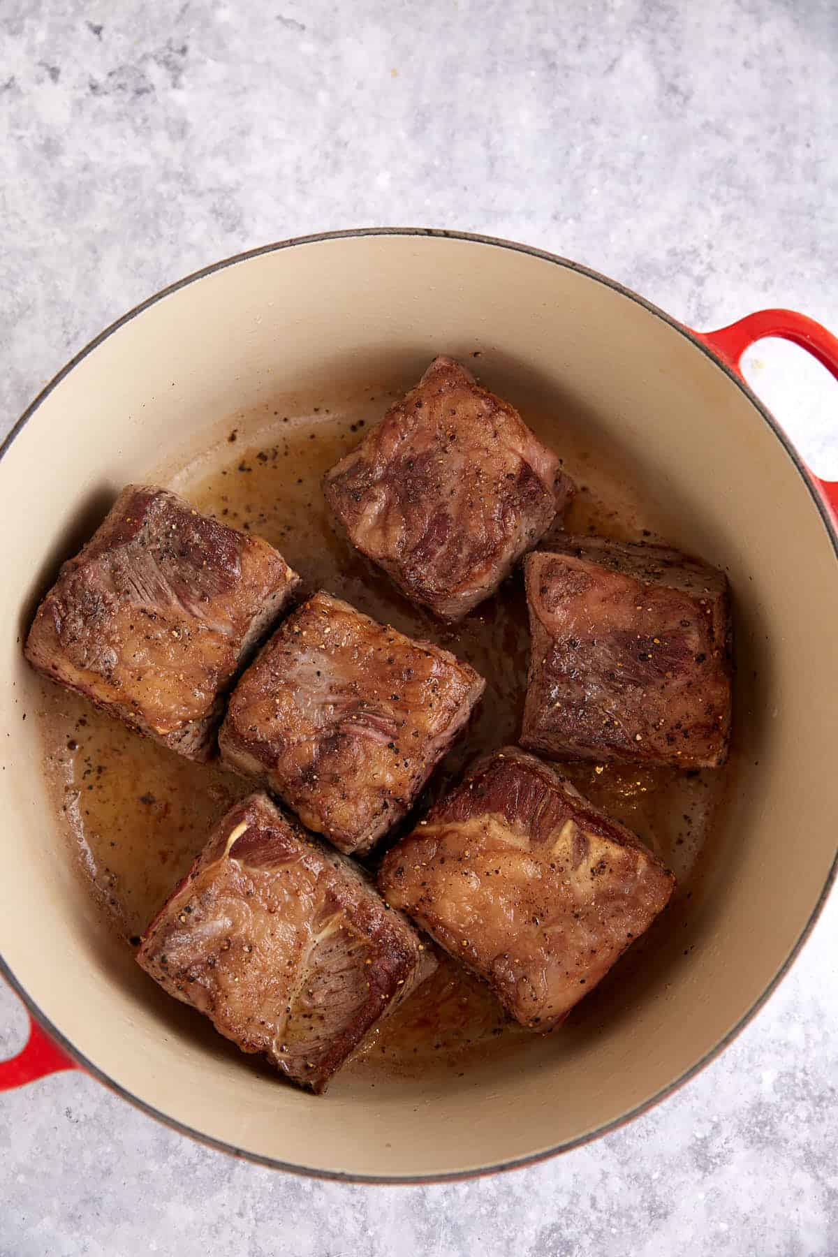 Short ribs browned in a Dutch oven.