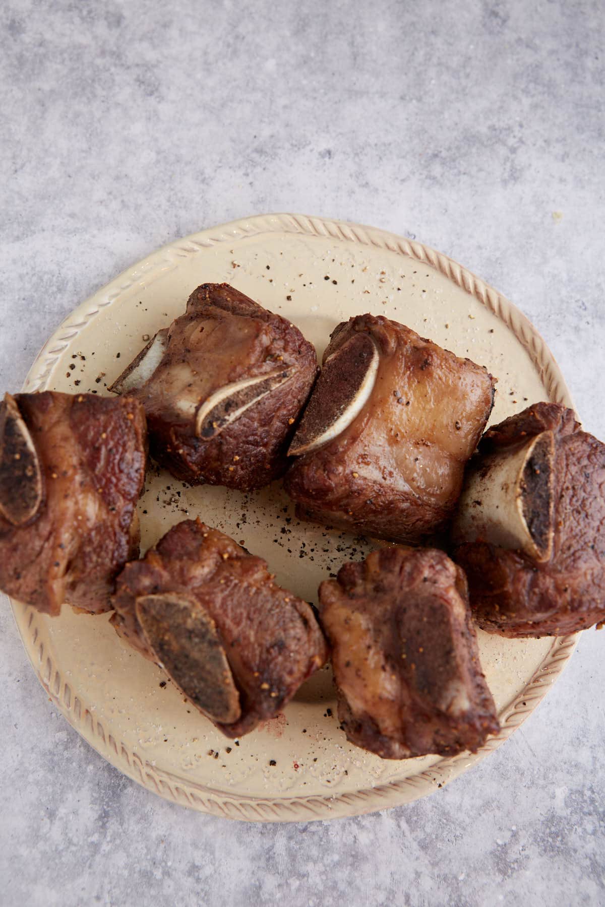Browned short ribs on a plate.