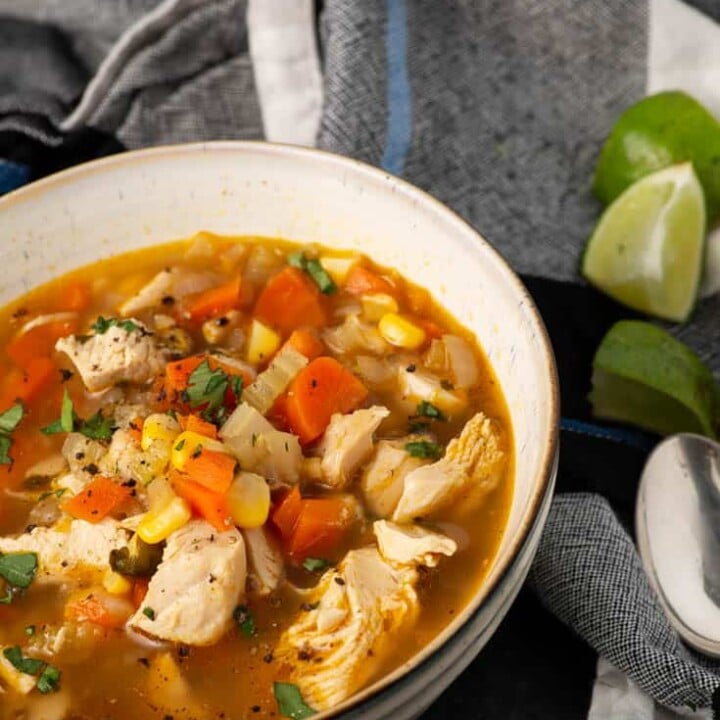 A bowl of chicken soup with coriander