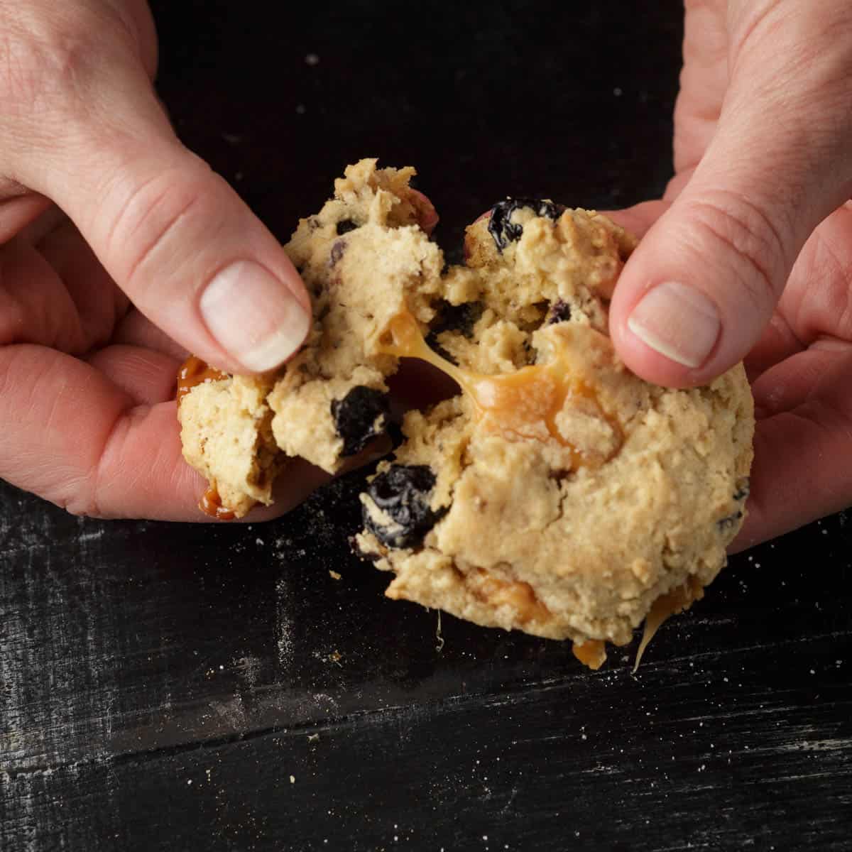 A caramel cookie being pulled apart