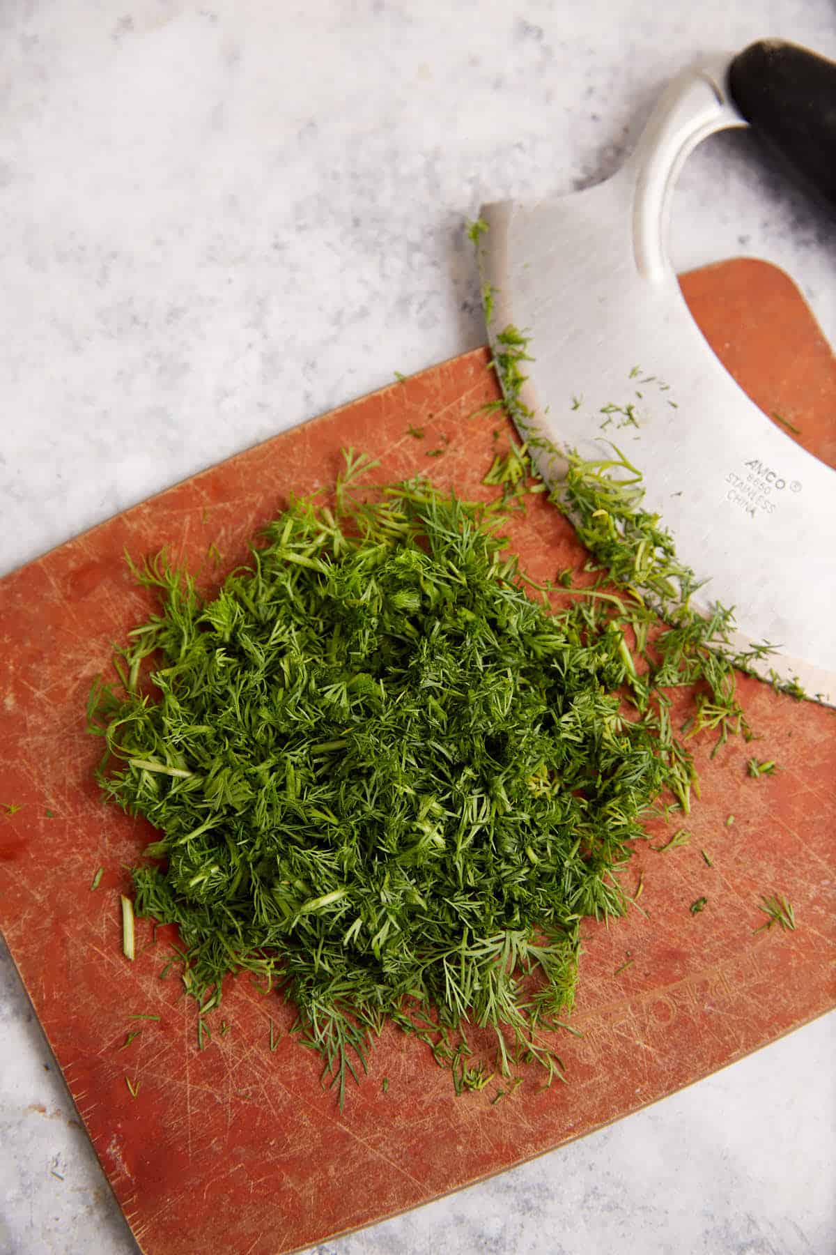 Dill chopped on a cutting board.