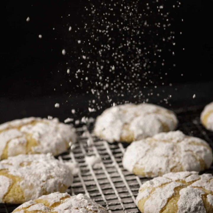Powdered sugar floating down onto lemon cookies.