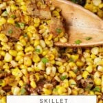 Close-up of skillet charred corn, offering a delectable view of blackened corn topped with chopped green herbs. A wooden spoon scoops the savory mix. In the background, butterandbaggage.com is displayed, with "Skillet Charred Corn" overlayed at the bottom of the image.