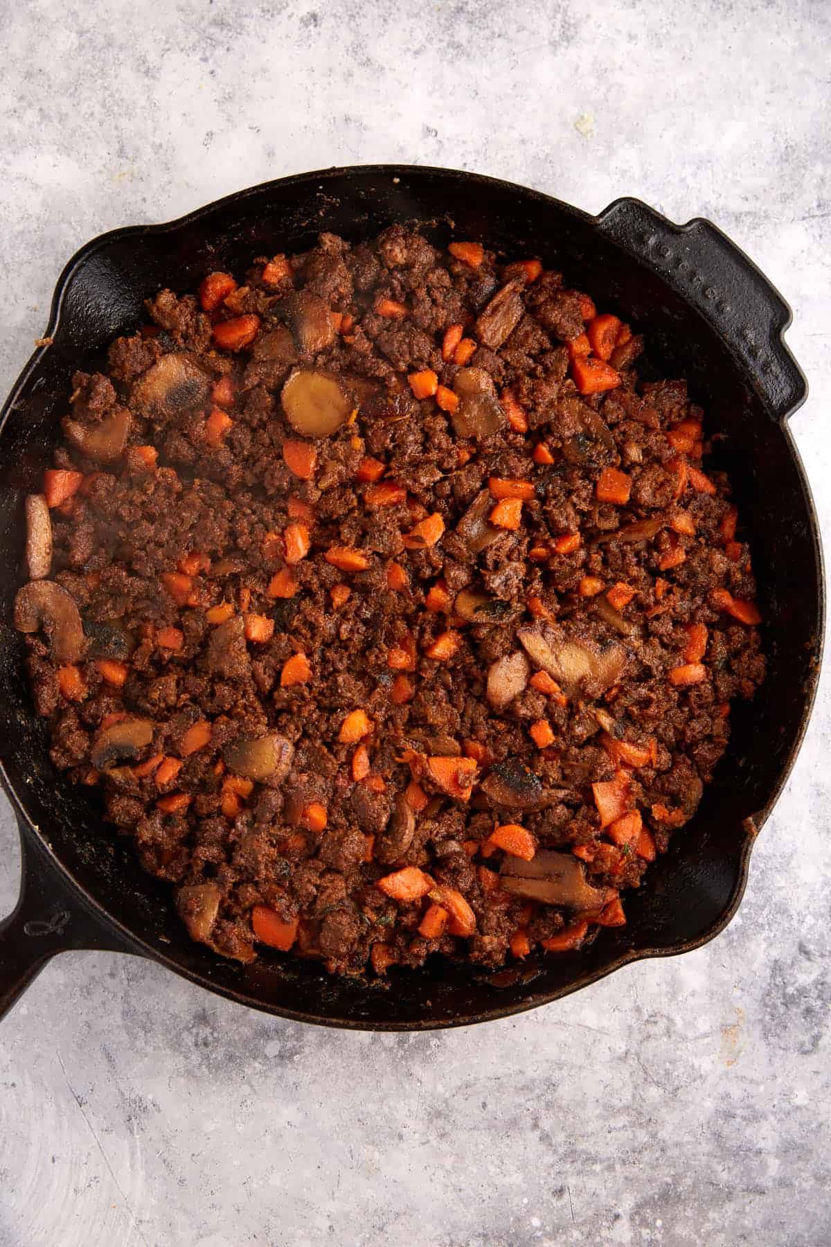 Beef mixture in a skillet.