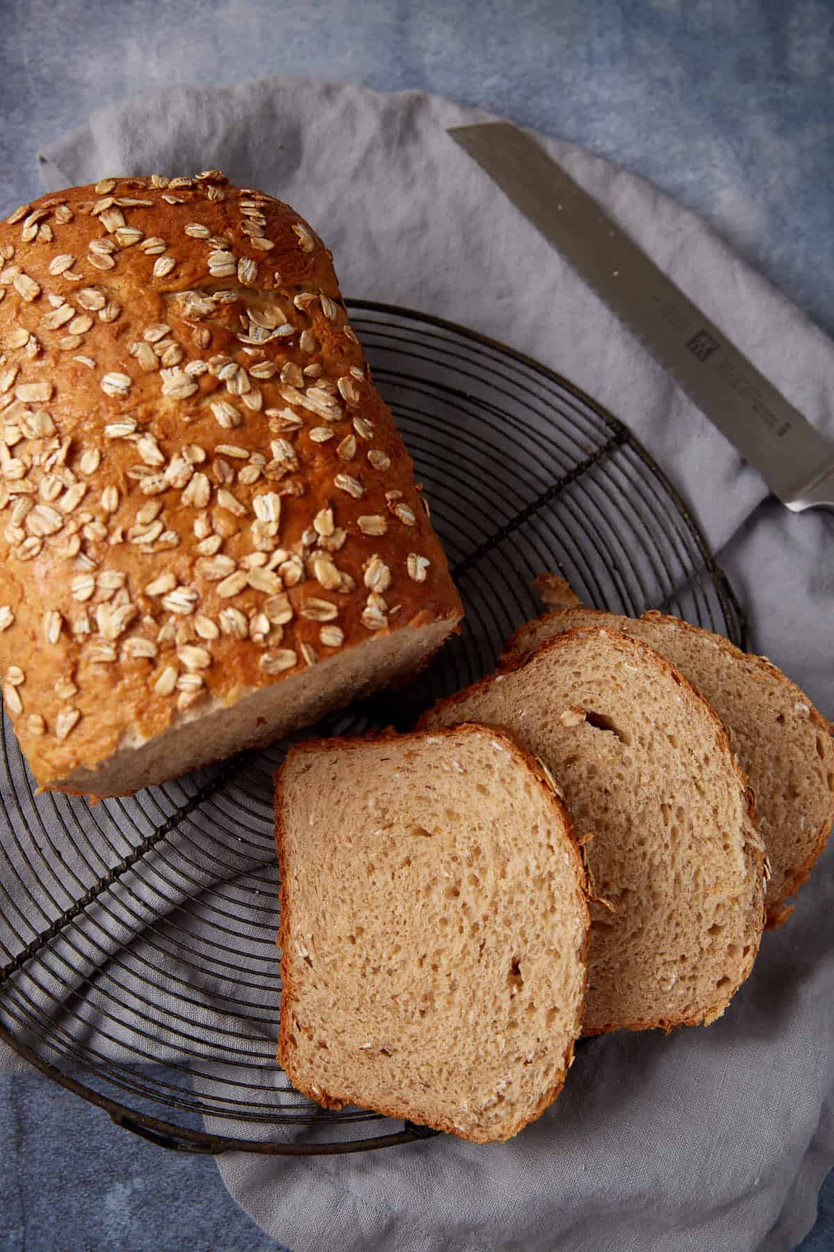 Honey oat bread sliced on a wire rack.