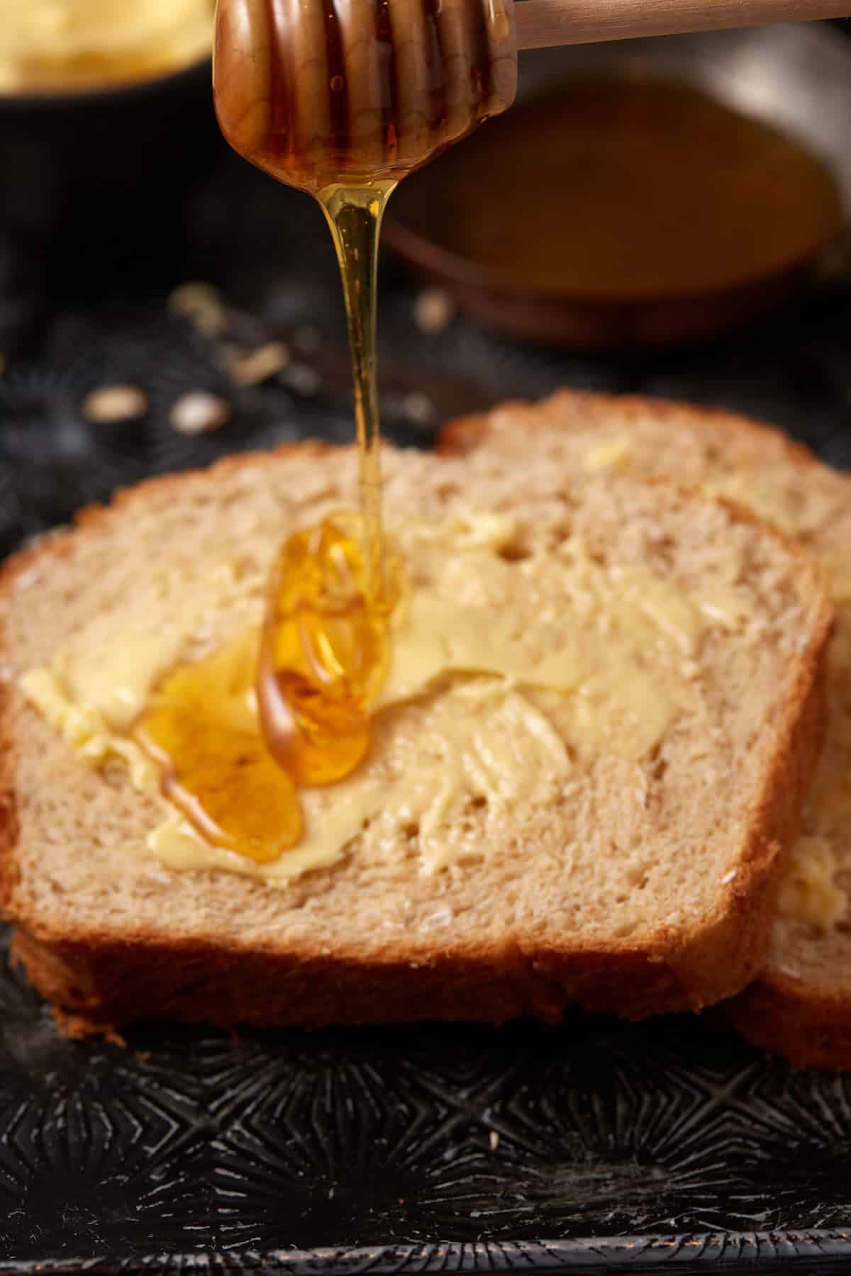 Honey being drizzled on bread.