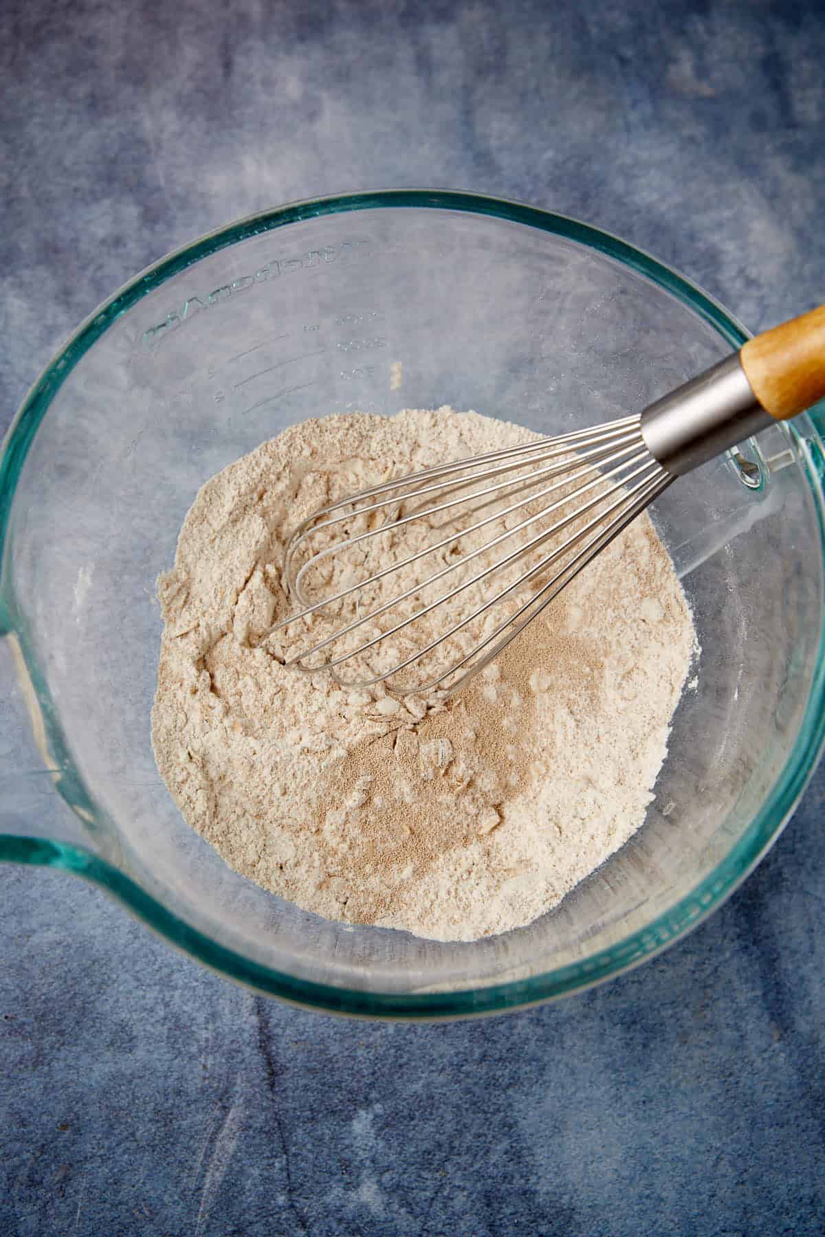 Dry ingredients in a bowl with a whisk.