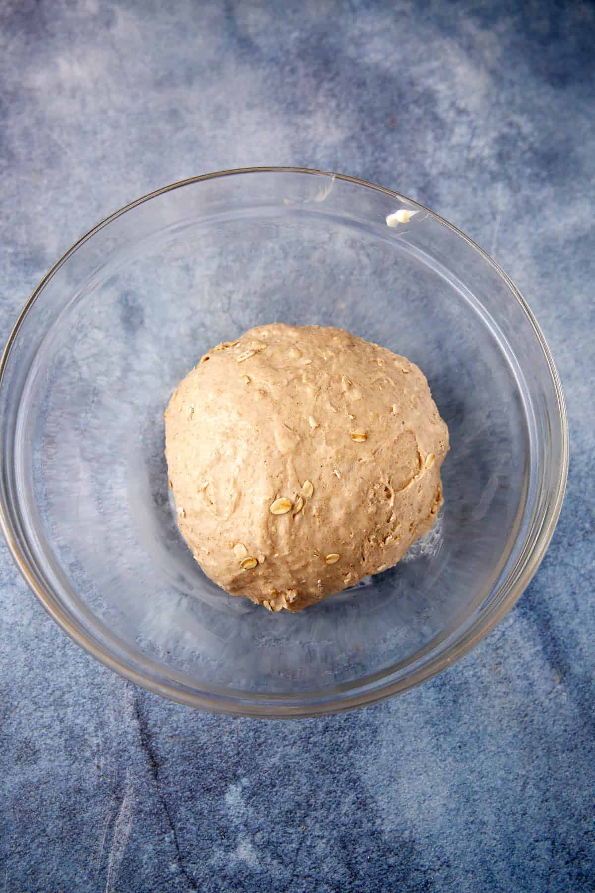 Bread dough before it has risen in a bowl.