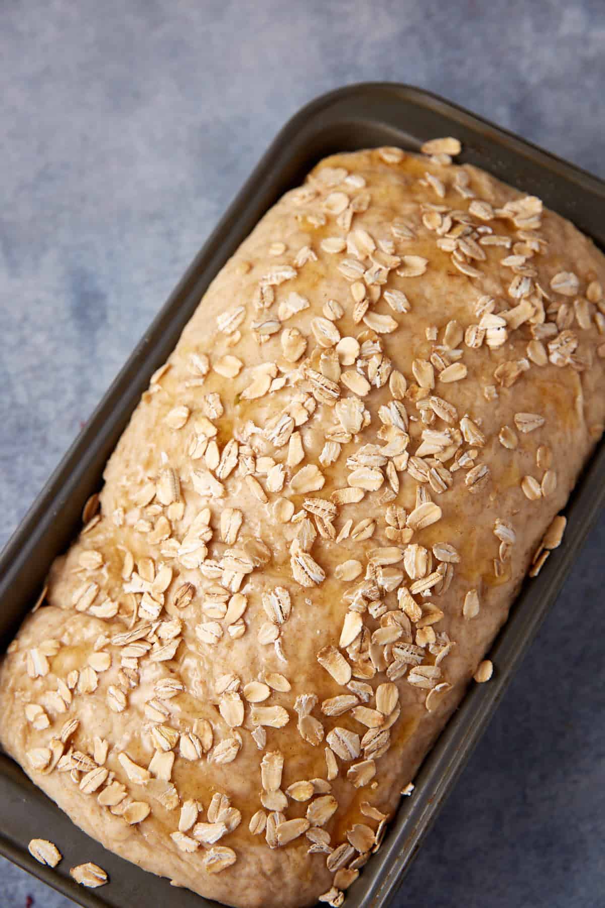 Honey oatmeal bread in a loaf pan.