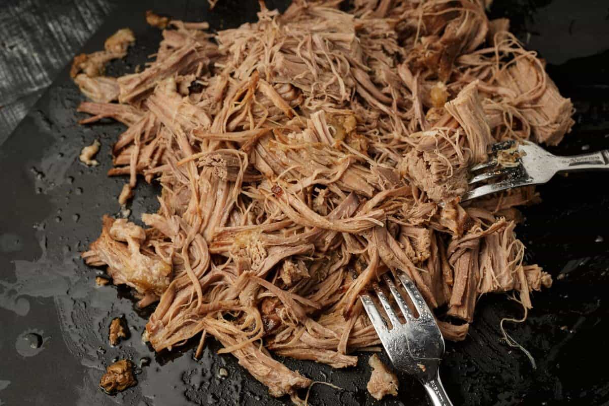 Brisket that has been cooked in a slow cooker, shredded.