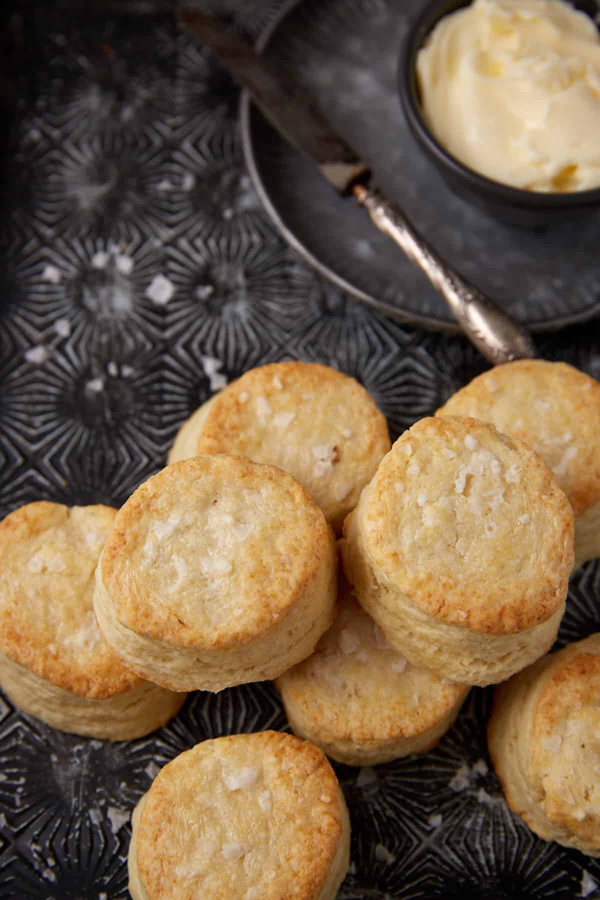 Southern biscuits on a tray next to a bowl of butter.