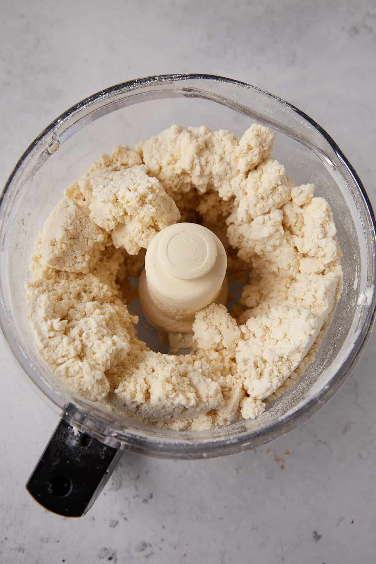 Buttermilk added to the biscuit dough in a food processor.