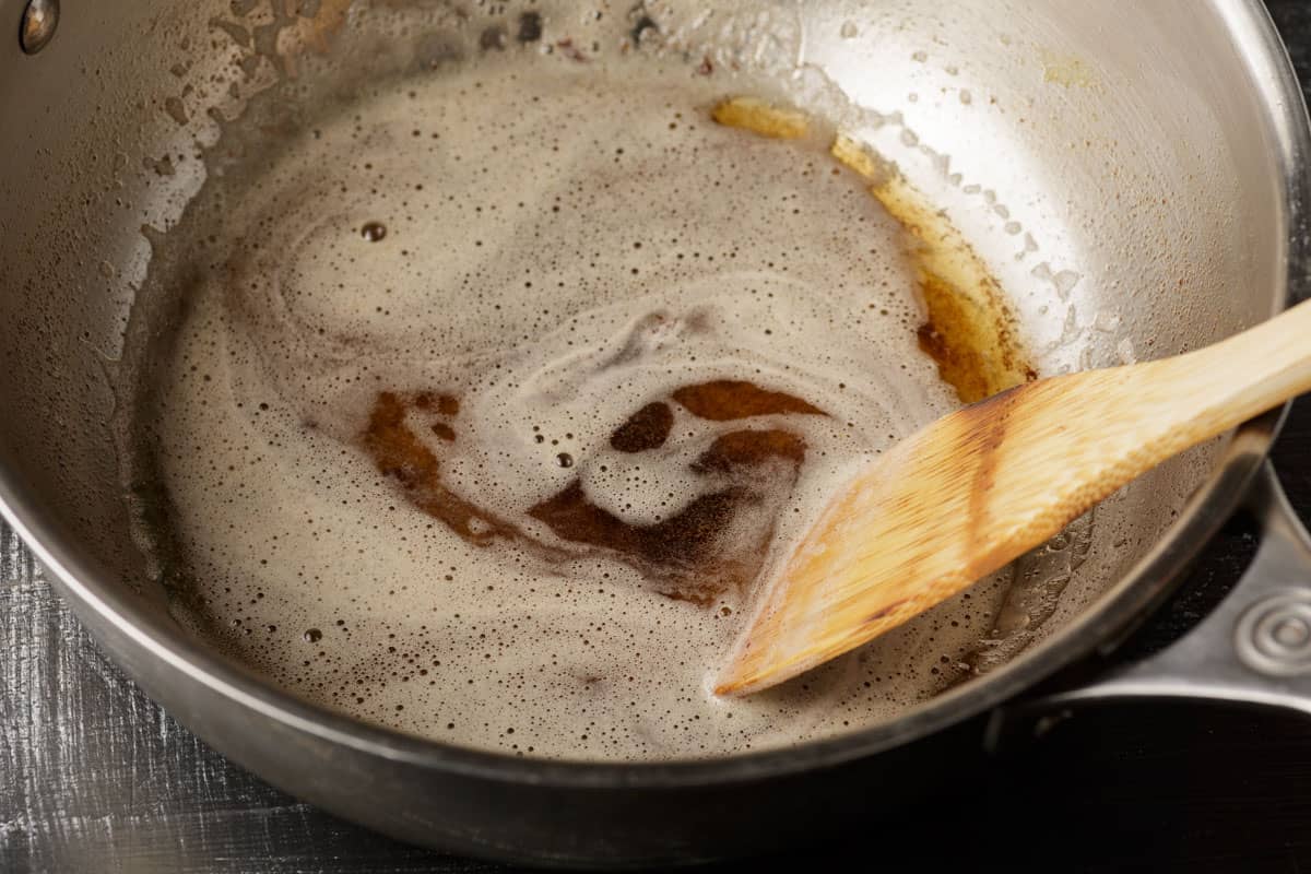 Browned butter in a skillet with a spatula.