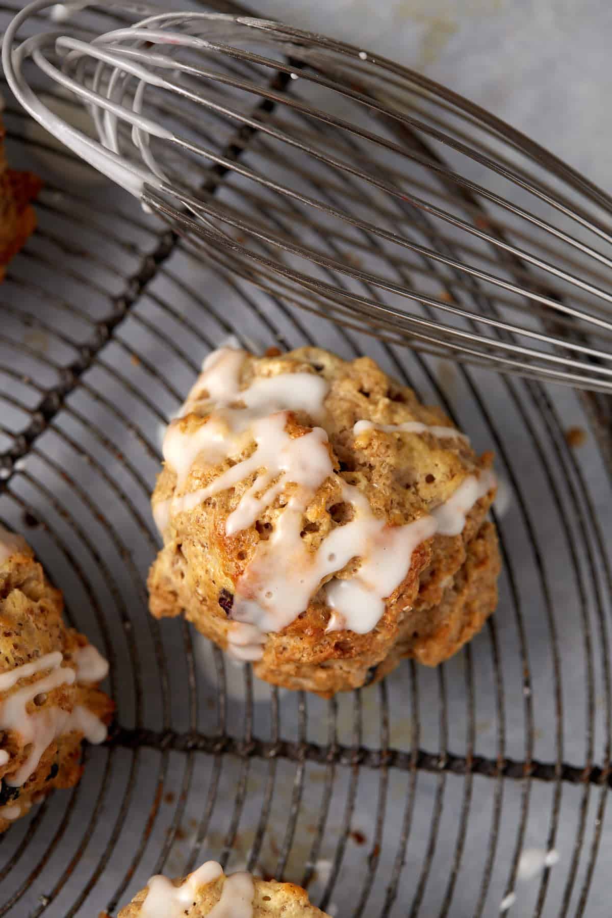 An oatmeal scone drizzled with glaze.