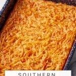 A baked dish of Southern Sweet Potato Pudding in a speckled blue and white pan, topped with a golden-brown crust. The text at the bottom reads "Southern Sweet Potato Pudding," and the website "butterandbaggage.com" is mentioned at the top.