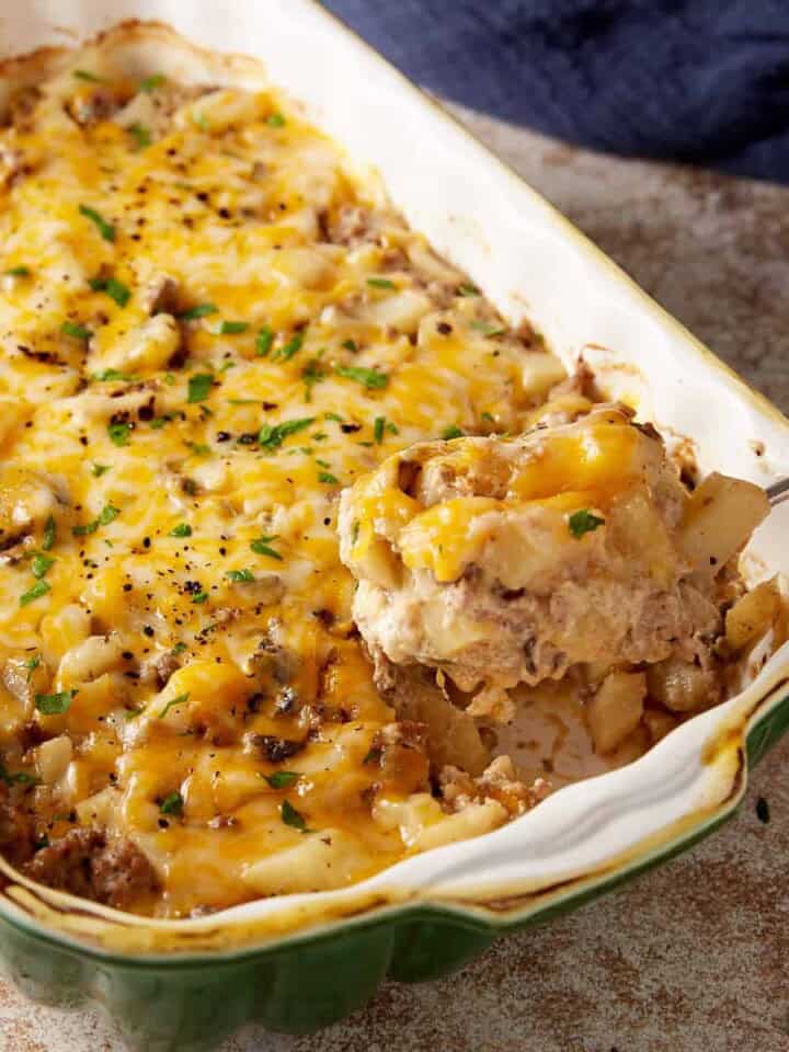 A serving spoon of ground beef potato casserole.