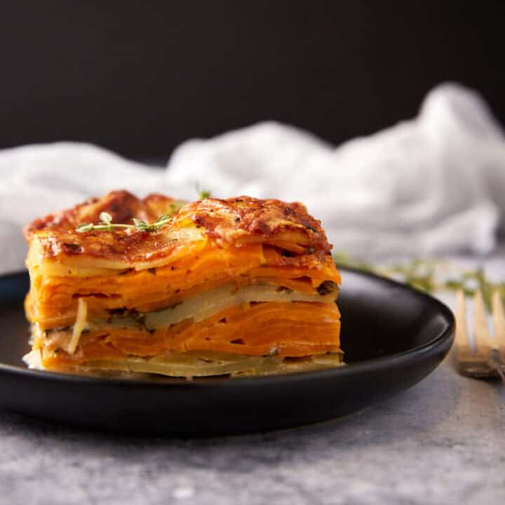 A square serving of scalloped sweet poatoes.