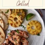 Grilled chicken thighs on a platter.