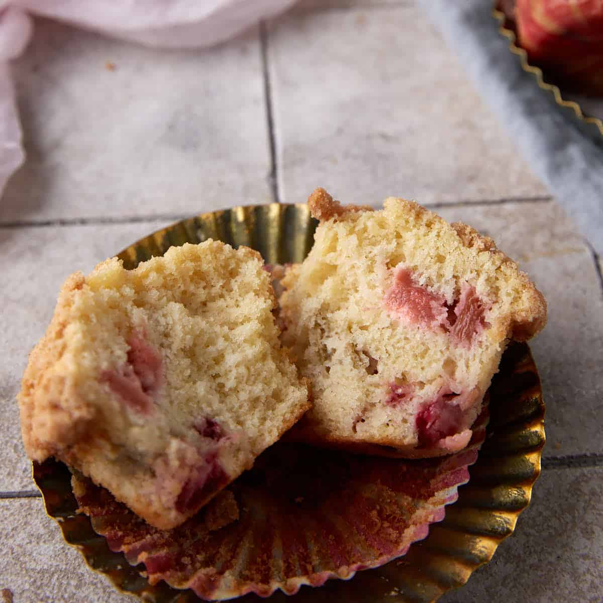 A strawberry rhubarb muffin broken open.