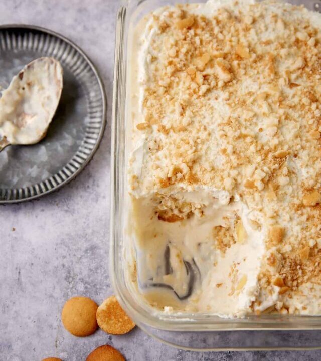 A glass baking dish of banana pudding with cream cheese.