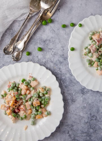 Pea salad with cheese on salad plates.