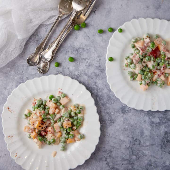 Pea salad with cheese on salad plates.