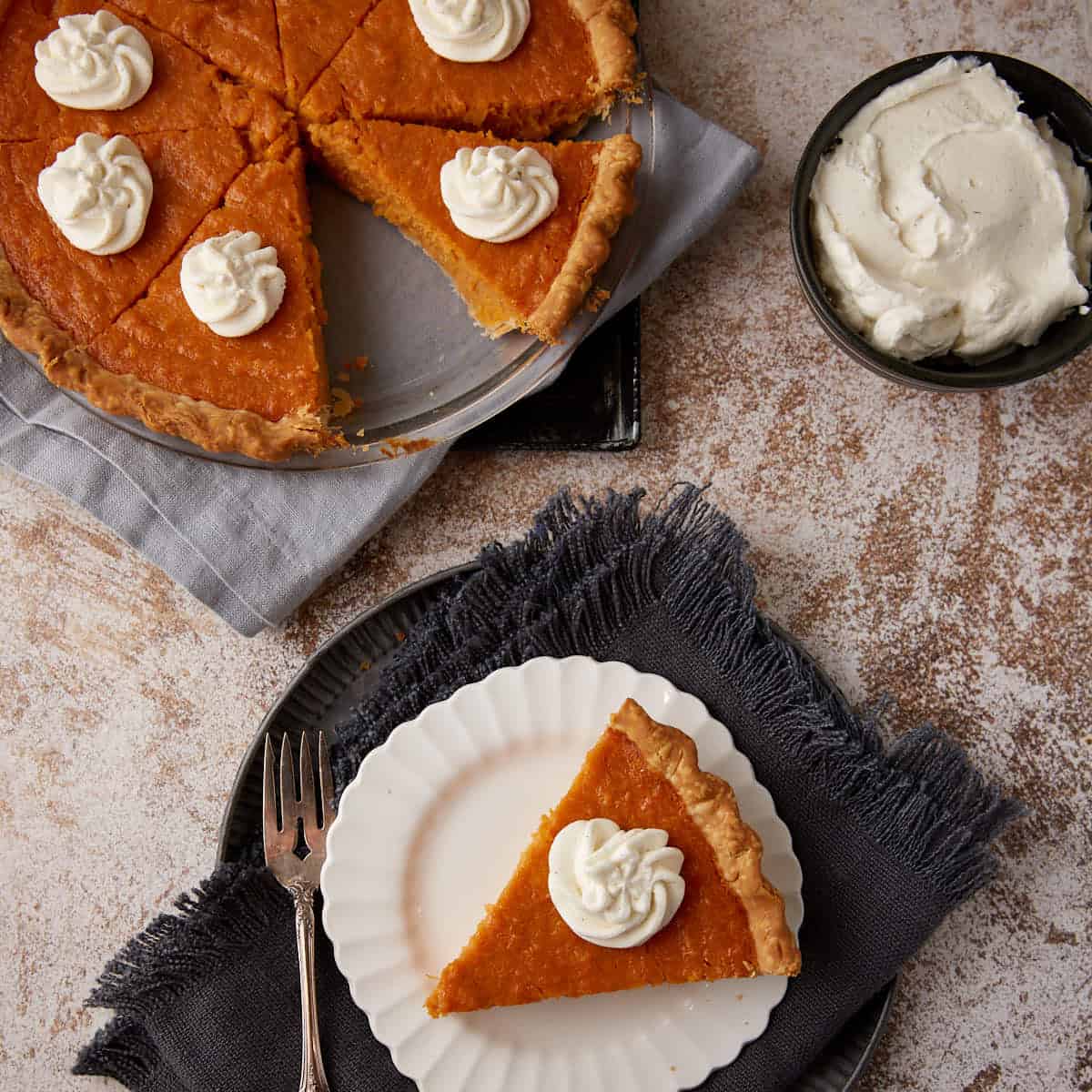 A Southern sweet potato pie next to a single slice.