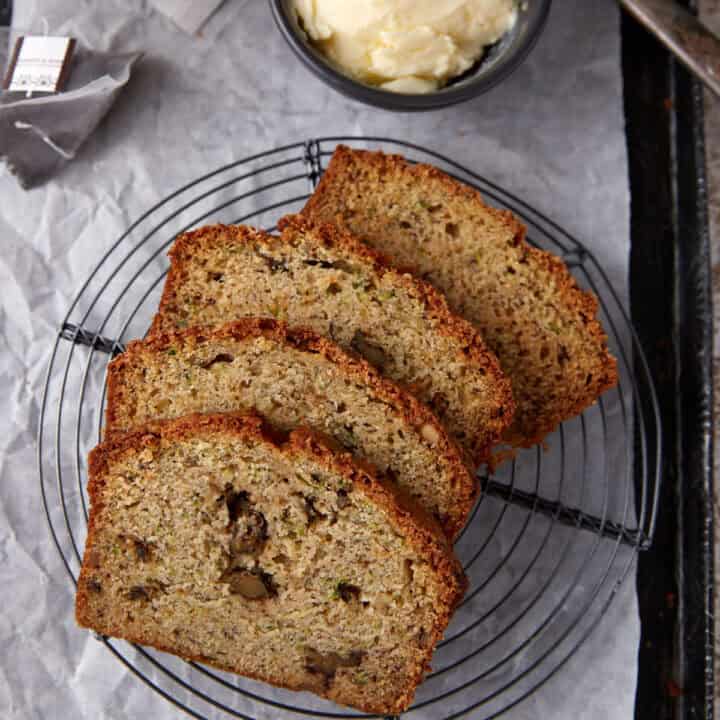 Four slices of banana bread on a round rack.