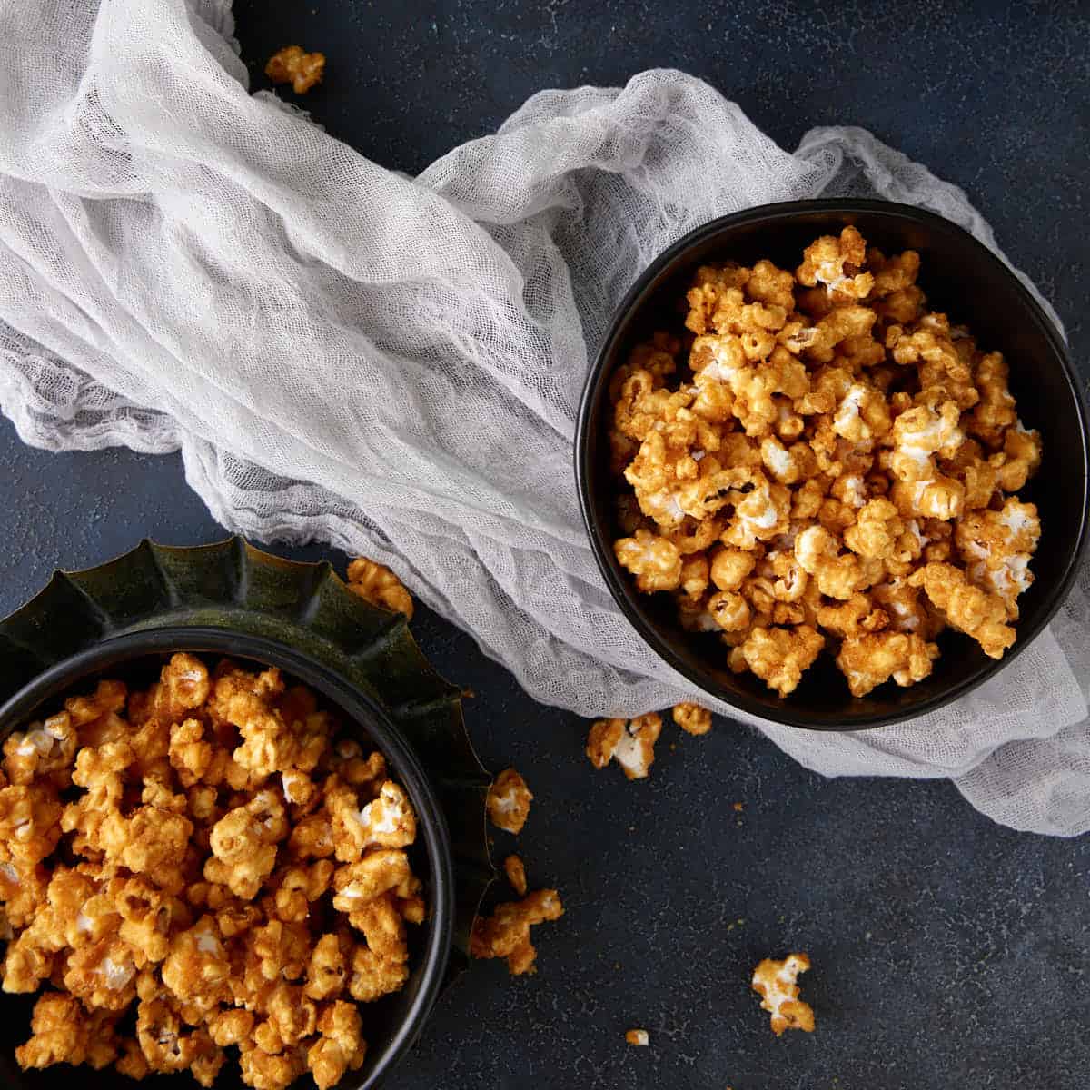 Two bowls of caramel popcorn.